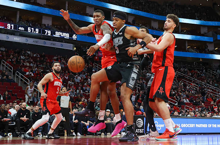 Rockets forward Jabari Smith Jr. (10) and San Antonio Spurs forward Keldon Johnson (3) attempt to get a loose ball during the fourth quarter at Toyota Center.